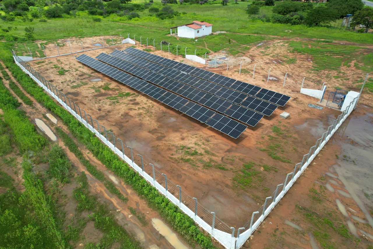 Usina solar em solo, cercada, vista aérea